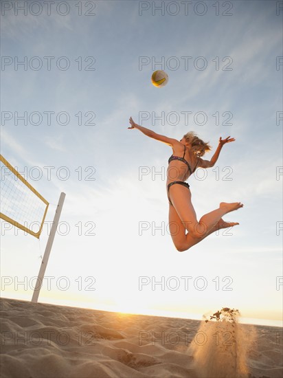 USA, California, Los Angeles, woman playing beach volleyball.