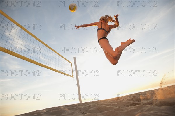 USA, California, Los Angeles, woman playing beach volleyball.