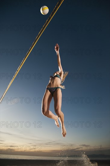 USA, California, Los Angeles, woman playing beach volleyball.