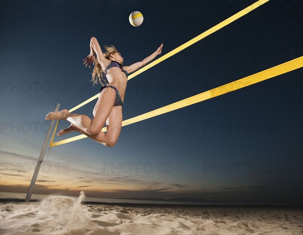 USA, California, Los Angeles, woman playing beach volleyball.