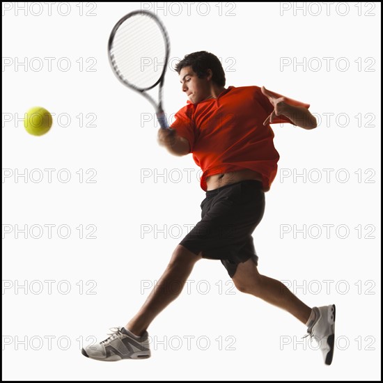 Young man playing tennis. Photo : Mike Kemp