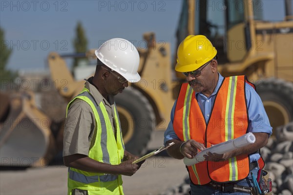 Two construction workers working on building site. Photo : Dan Bannister