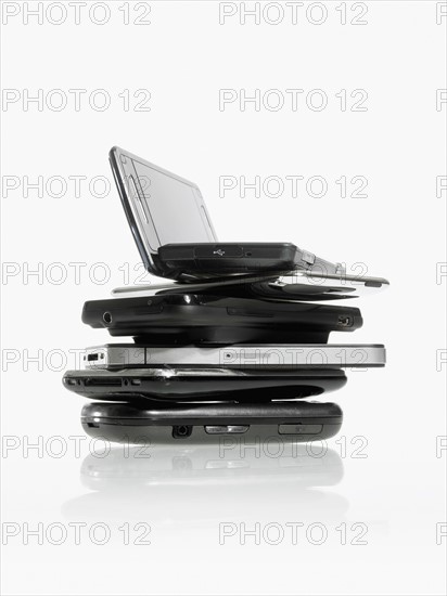 Studio shot of pile of laptops and palmtops. Photo : David Arky