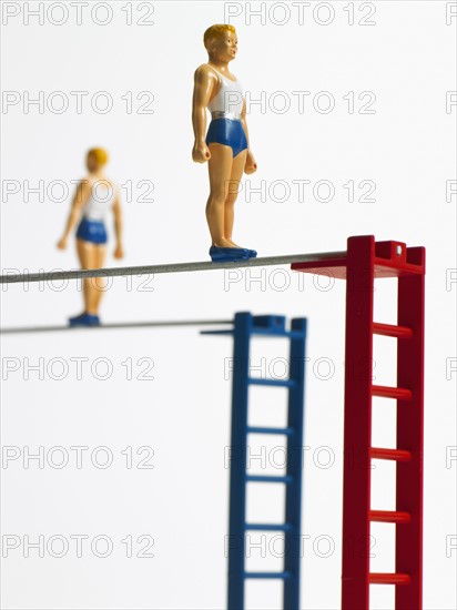 Studio shot of figurines on ladders. Photo : David Arky