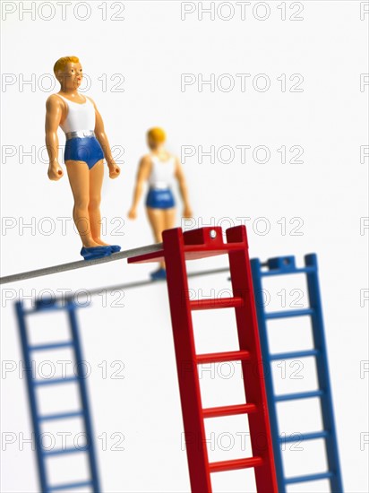 Studio shot of figurines on ladders. Photo : David Arky