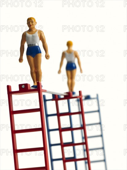 Studio shot of figurines on ladders. Photo : David Arky