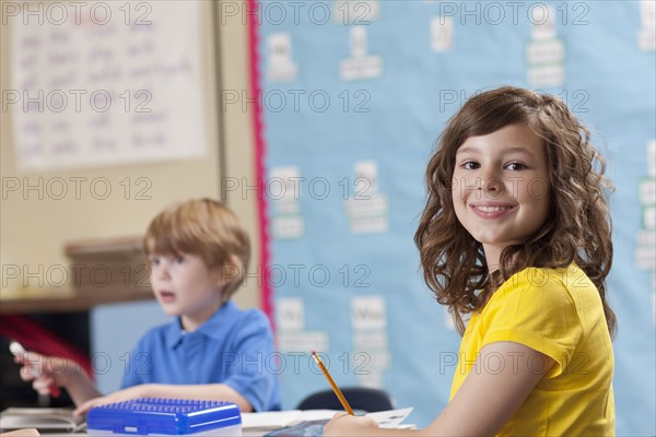 Girl (10-11) and boy (6-7) in classroom. Photo : Dan Bannister