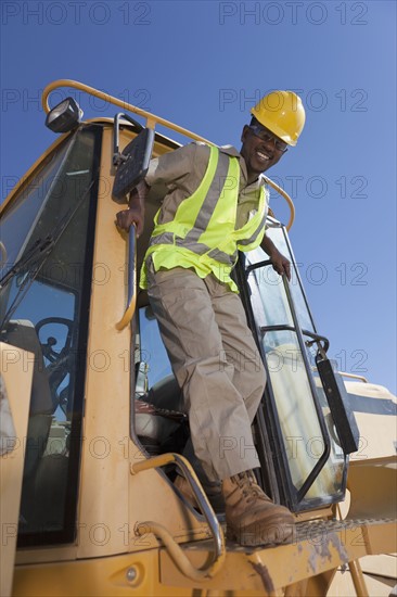 Portrait of construction worker on mechanical digger. Photo : Dan Bannister