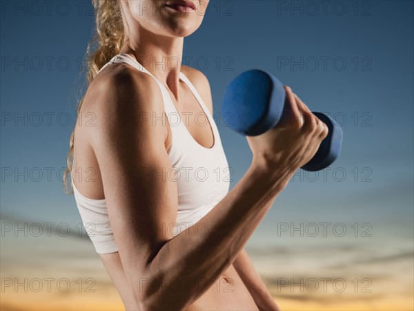 USA, California, Los Angeles, woman exercising with dumbbells.