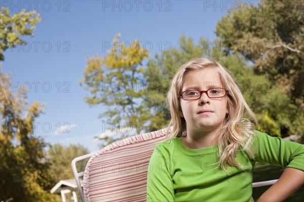 Outdoor portrait of blonde USA, Utah, girl (8-9) in glasses. Photo : Tim Pannell