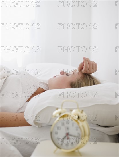 USA, New Jersey, Jersey City, Young woman sleeping in bed. Photo : Jamie Grill Photography