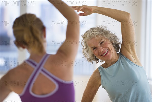 USA, New Jersey, Jersey City, Senior woman with fitness instructor at gym.