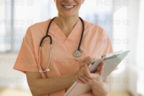 USA, New Jersey, Jersey City, Female doctor writing medical report.
