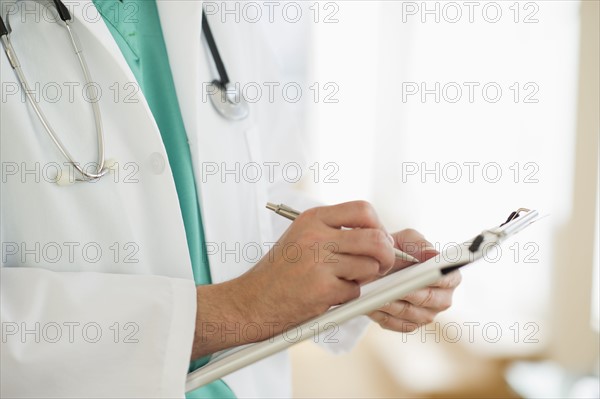 USA, New Jersey, Jersey City, Male doctor writing medical report.