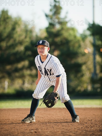 Boy (10-11) playing baseball.