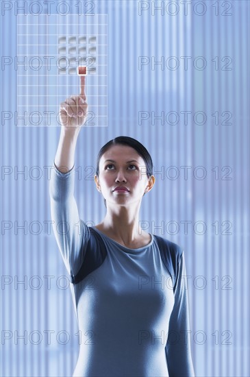 Woman touching glass panel.