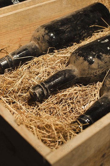 Old wine bottles in wooden box.