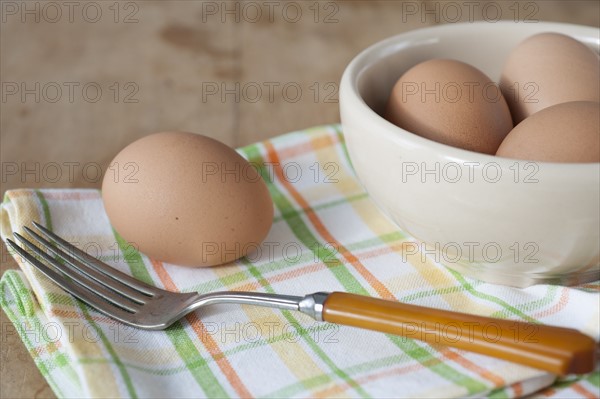 Bowl of boiled eggs with fork.