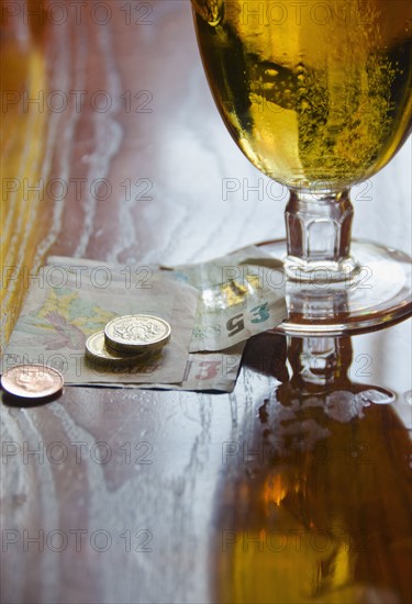 British currency and beer on table.