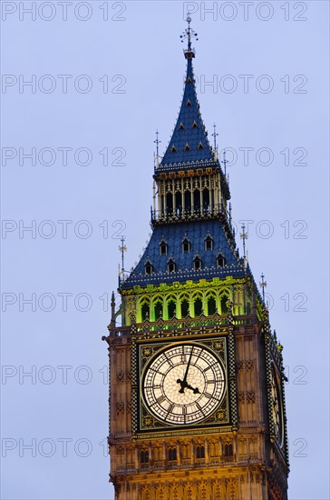 United Kingdom, London, Big Ben clock face illuminated at dusk.