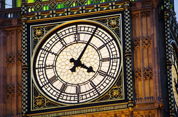 United Kingdom, London, Big Ben clock face illuminated at dusk.