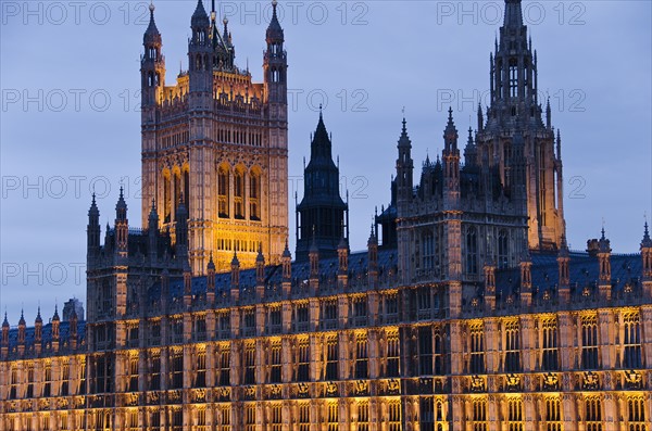 United Kingdom, London, Houses of Parliament illuminated at dusk.