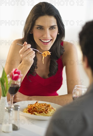 Young couple eating dinner.