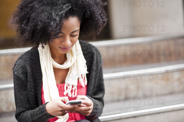 USA, Washington State, Seattle, Cheerful young woman text messaging. Photo : Take A Pix Media