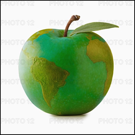 Apple in shape of globe, studio shot. Photo : Mike Kemp