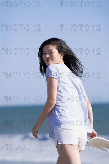 USA, California, Point Reyes, Young woman walking near sea. Photo : Noah Clayton