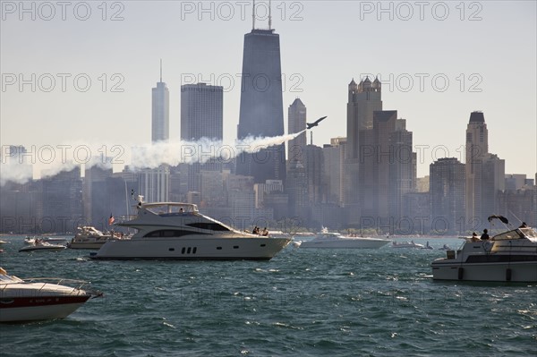 USA, Illinois, Chicago, motor boats and airplane with cityscape at background. Photo : Henryk Sadura