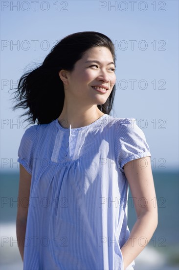 USA, California, Point Reyes, Pensive young woman at coast. Photo : Noah Clayton