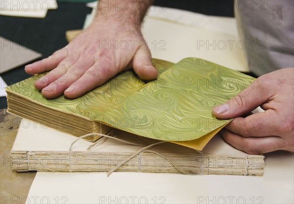 Hands binding book.