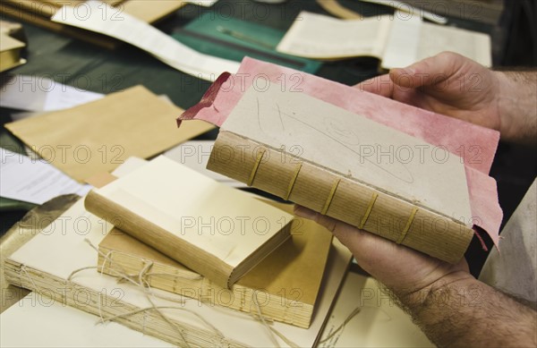 hands binding book.