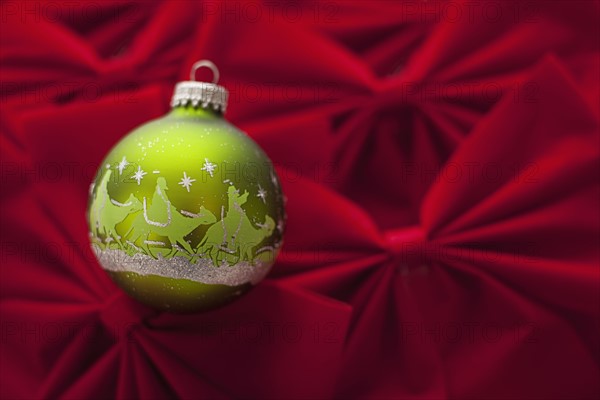 Studio Shot of red velvet bows with green Christmas ornament. Photo : Mike Kemp