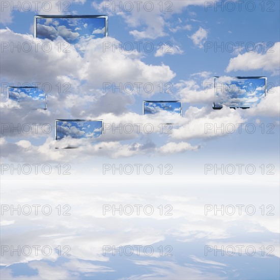 Digital composite with cloudscape and monitors.