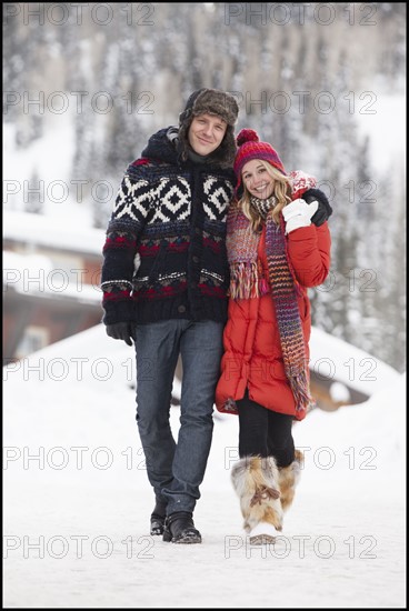 USA, Utah, Salt Lake City, Portrait of young couple walking in snow. Photo : Mike Kemp