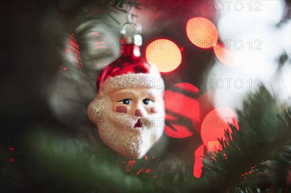 Santa Claus Christmas decoration hanging on Christmas tree, studio shot.