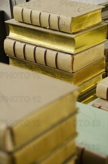 Books stacked in binding workshop.