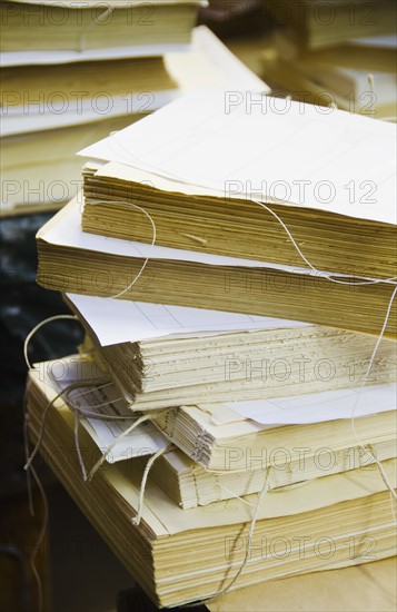 Close up of books without covers being prepared for binding.