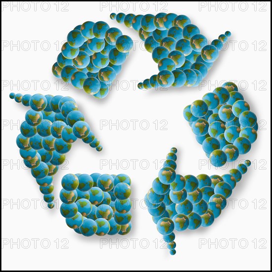 Studio Shot of recycling symbol made of globes. Photo : Mike Kemp