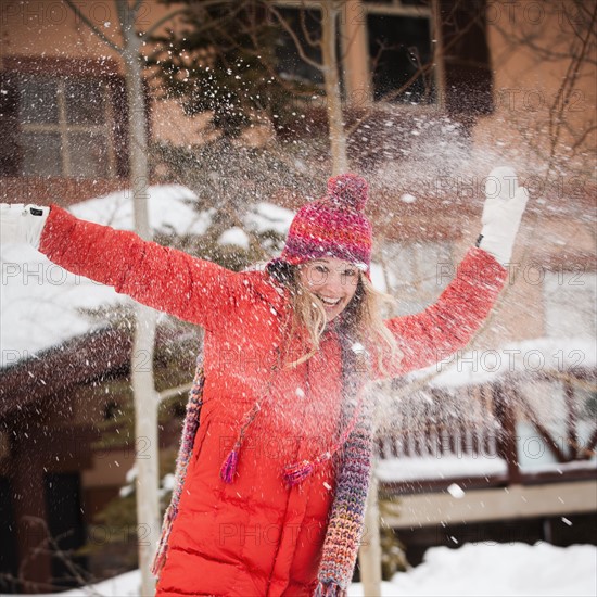 USA, Utah, Salt Lake City, Portrait of young woman playing in snow. Photo : Mike Kemp