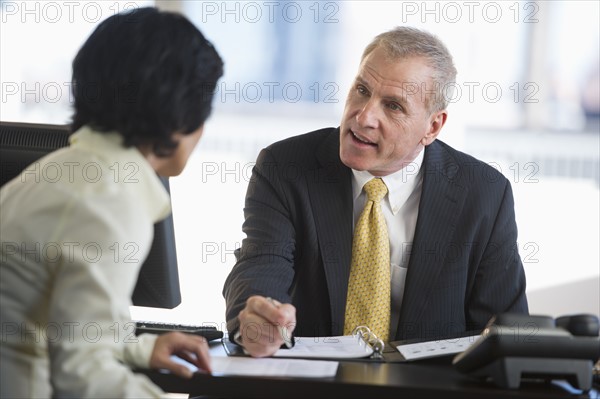 Businesswoman and businessman at meeting.