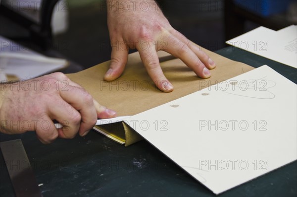 Close up of hands of book binder.