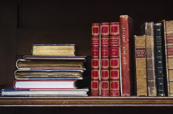 Close up of antique books on shelf.