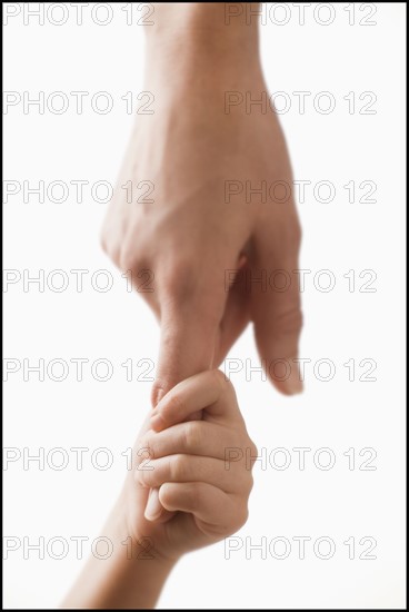 Studio shot of hands of woman and girl (2-3). Photo : Mike Kemp