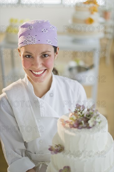 Portrait of young woman with wedding cake.