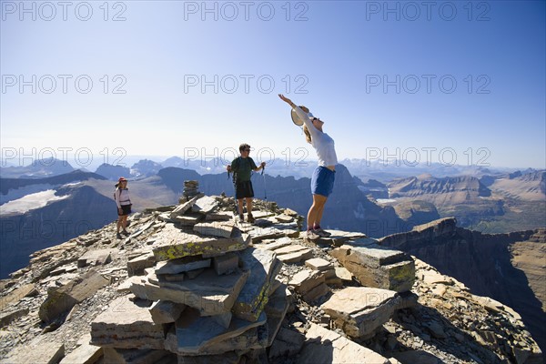 USA, Montana, Glacier National Park, Hikers on the top of mountain. Photo : Noah Clayton