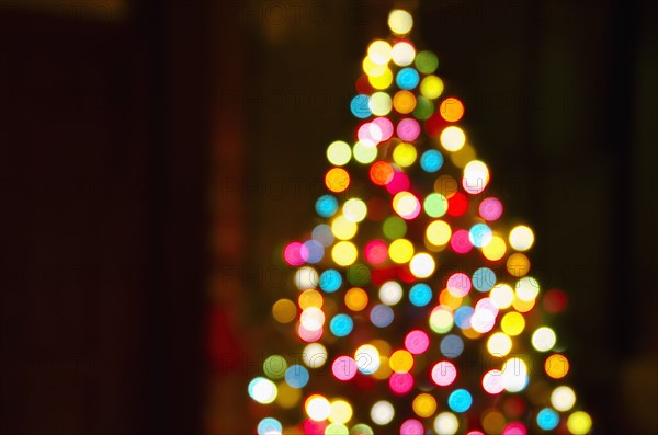 Defocused Christmas tree with colorful lights.