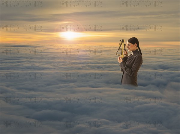 Women above clouds looking through sextant.